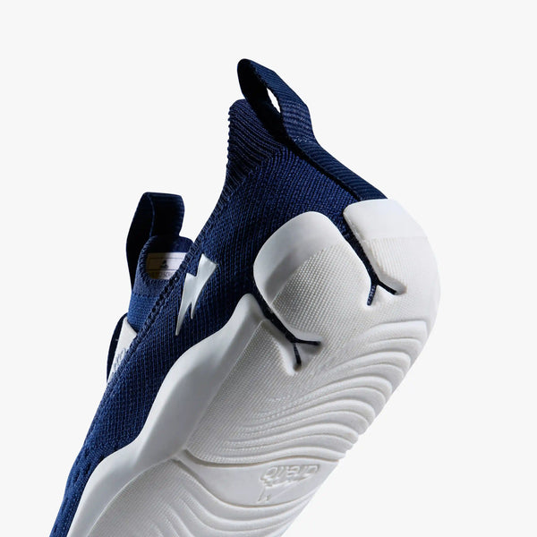 Macro close-up of the heel and outsole of an Aretto shoe, detailing the patented, flexible Y-shaped Supergrooves sole technology. (Sizes S3 & S4)