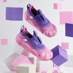Aretto Leaps Pixl Pixel Berry pink and purple kids shoes floating amidst pink and purple geometric blocks. S1 & S2